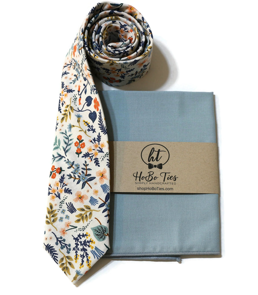 White Metallic Wildwood Floral Necktie paired with a pocket square, showcasing handcrafted neckties and unique floral designs.