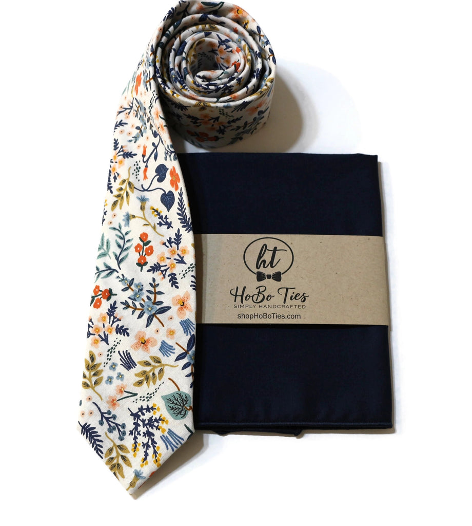 White Metallic Wildwood Floral Necktie paired with a dark pocket square, showcasing handcrafted neckties for men.