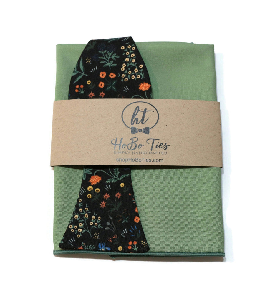 Black Menagerie Garden Floral Bow Tie displayed with matching pocket square, showcasing handcrafted quality and unique floral patterns.
