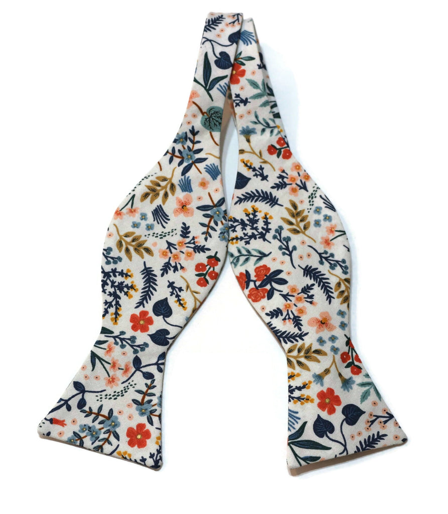 White Metallic Wildwood Floral Bow Tie featuring a vibrant floral pattern, perfect for men's wedding accessories and handcrafted neckties.