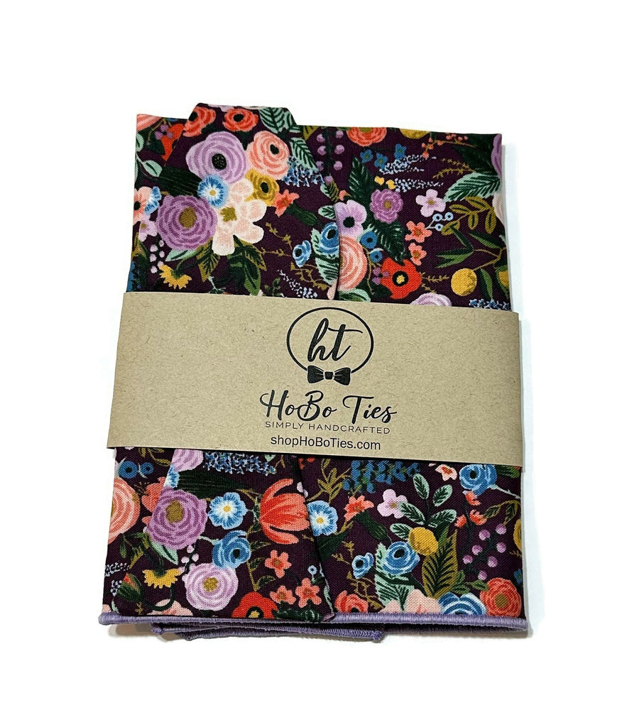 Eggplant Garden Party Petite Floral Bow Tie packaged with vibrant floral design, handcrafted neckties, handmade bow ties.