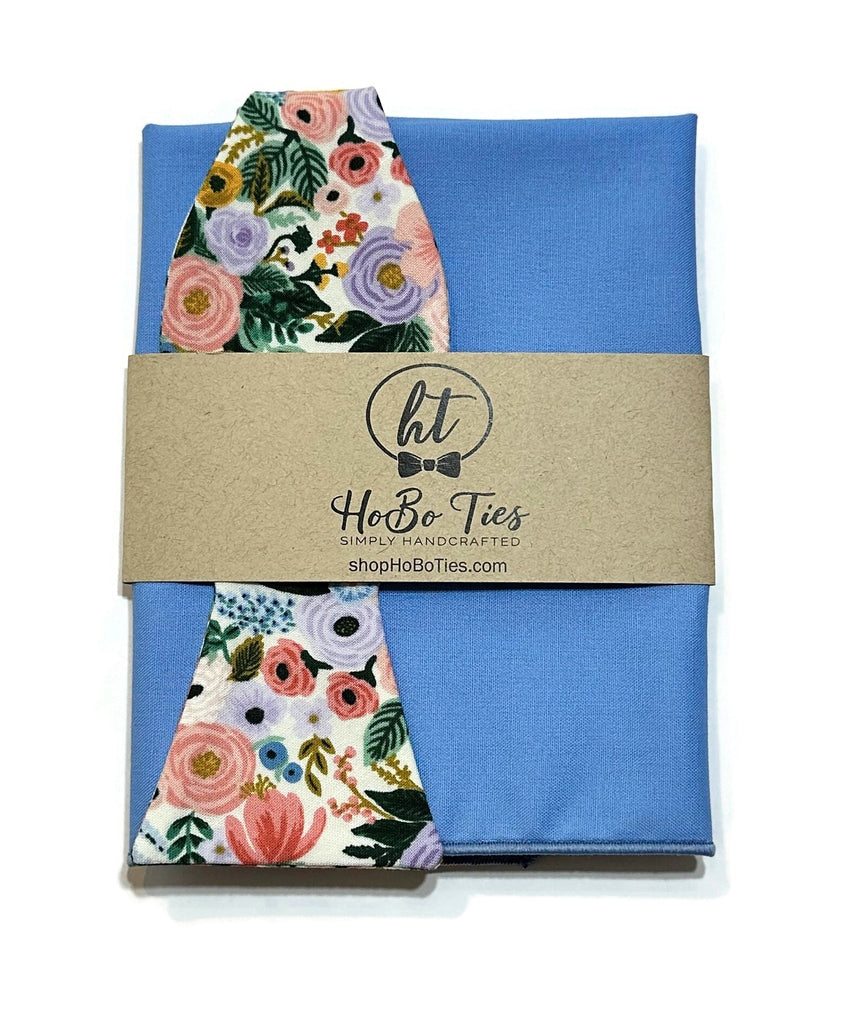 Ivory Garden Party Petite Floral Bow Tie presented with blue fabric and floral pattern strap, perfect for formal wear accessories men.