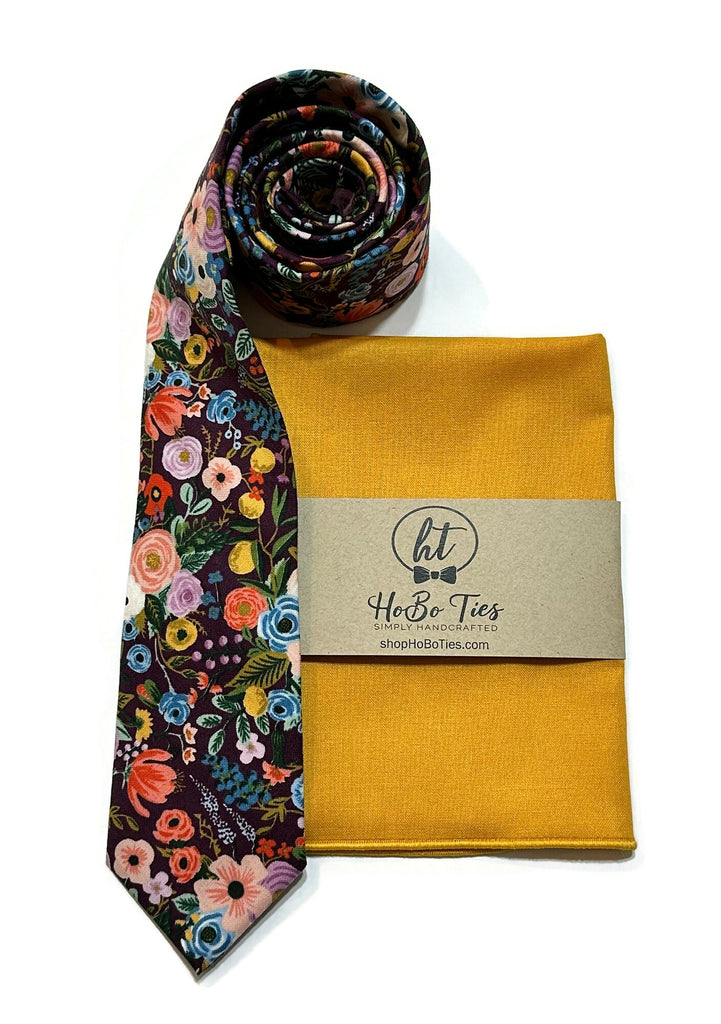 Eggplant Garden Party Petite Floral Necktie with a floral pattern and a gold pocket square, handcrafted neckties.