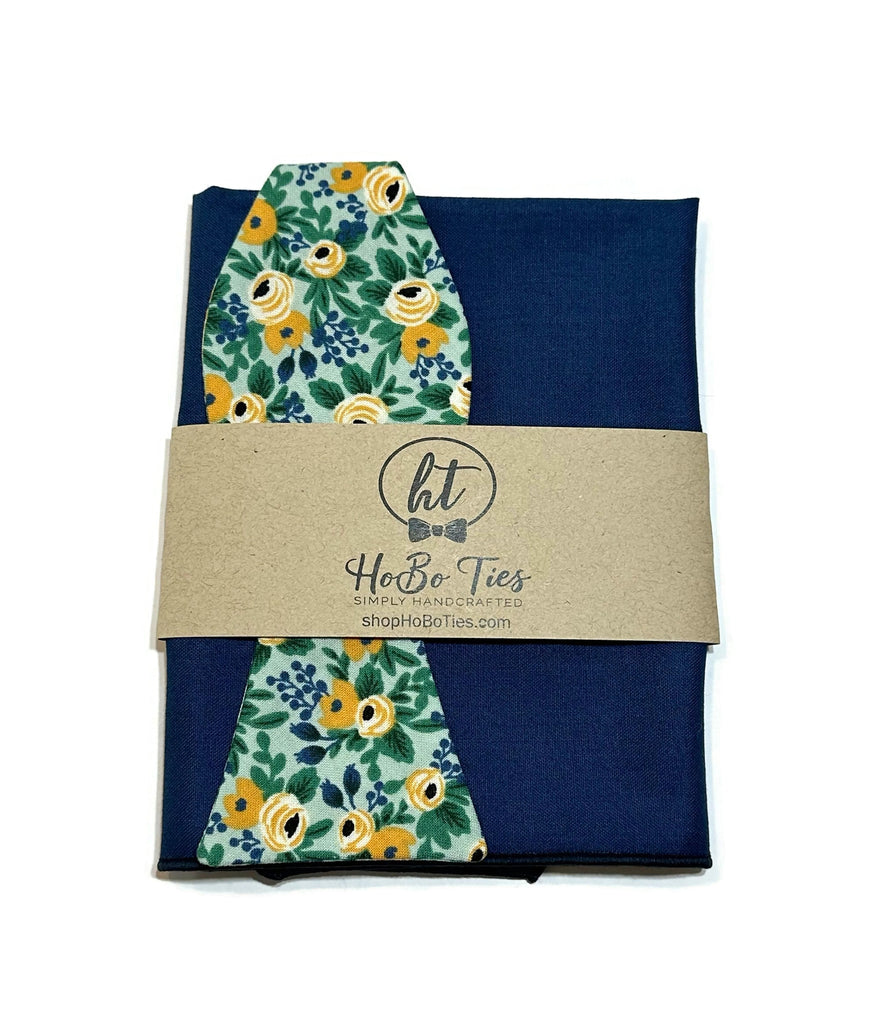 Mint Rosa Floral Bow Tie paired with a navy pocket square, showcasing unique floral patterns for men’s accessories.