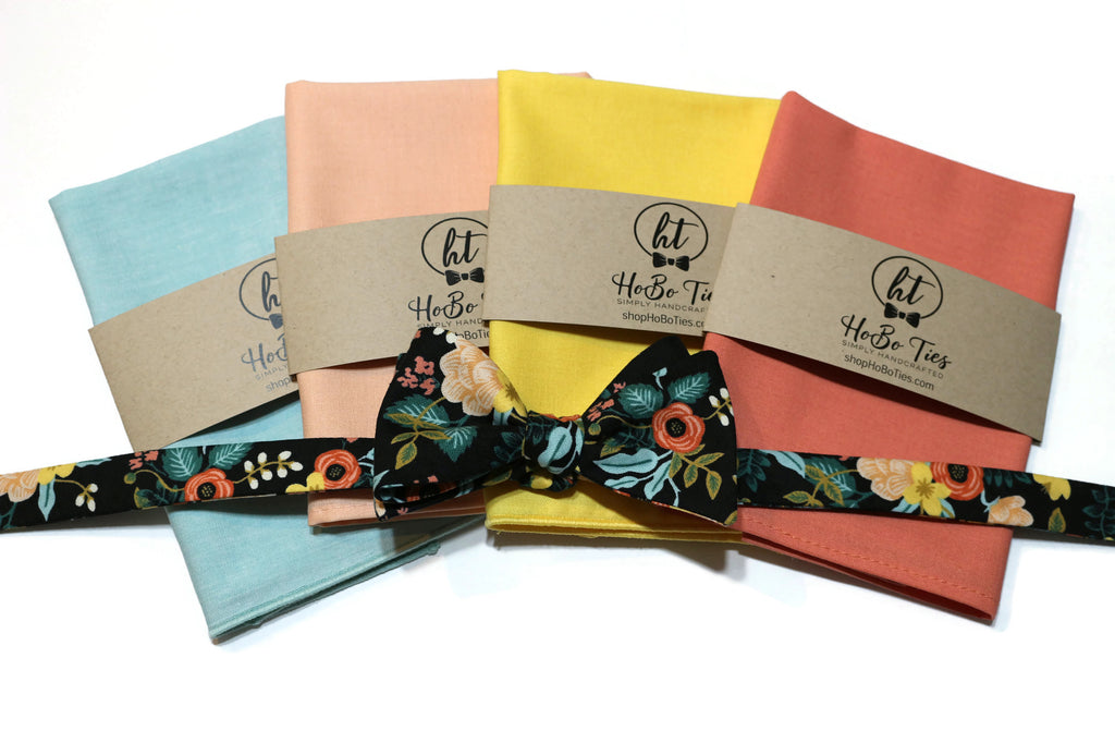 Black Birch Floral Bow Tie paired with colorful pocket squares from HeBo Ties, perfect for men's wedding accessories.