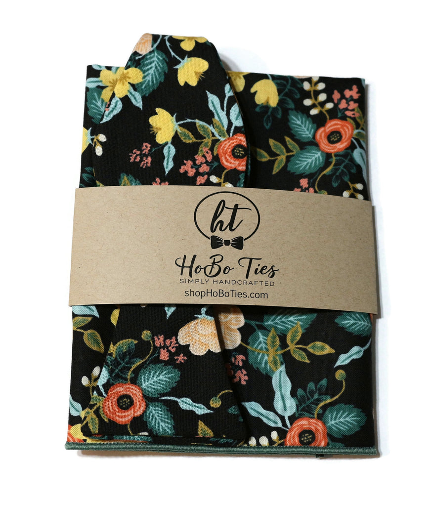 Black Birch Floral Bow Tie featuring vibrant floral patterns on a black background, perfect for men’s accessories and weddings.