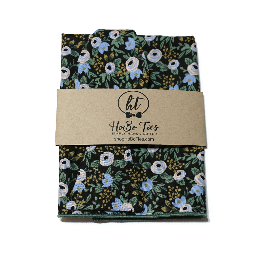 Black Rosa Floral Bow Tie on black background with floral design, handcrafted men’s bow ties, unique patterns, handmade accessories.