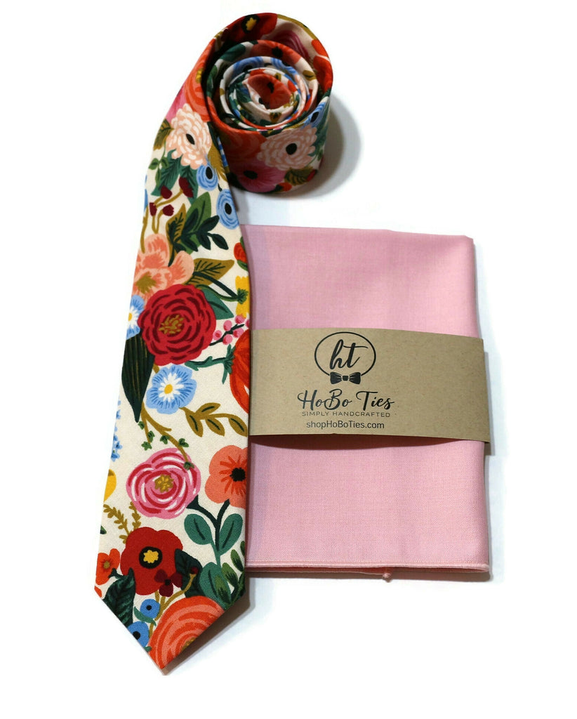 Cream Garden Party Floral Necktie alongside a pink pocket square, handcrafted neckties and unique accessories for men.