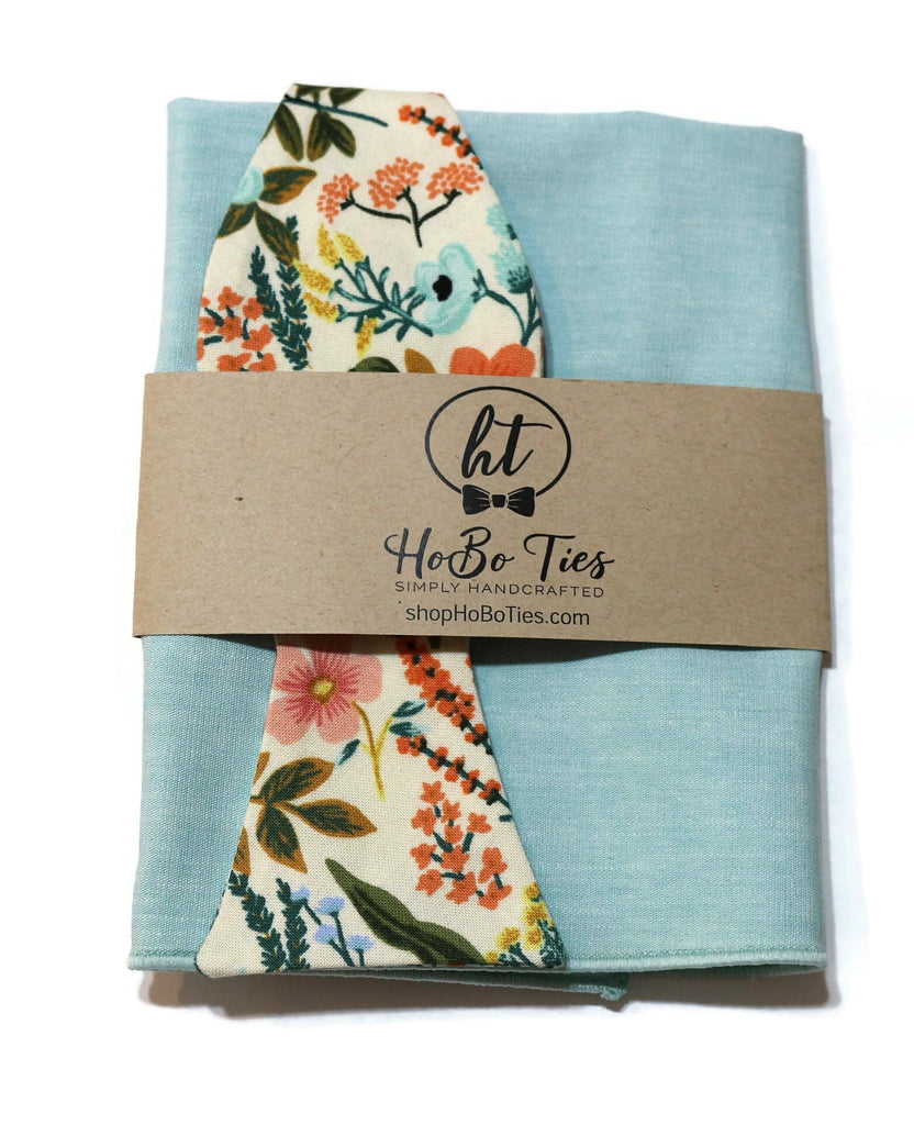 Natural Amalfi Floral Bow Tie with light blue fabric and floral pattern, perfect for weddings and men's accessories.