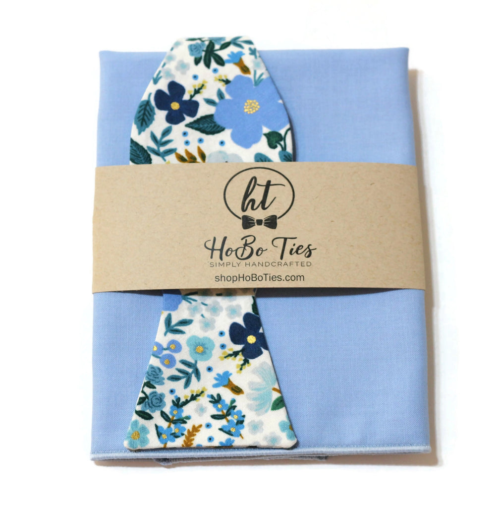 Blue Wild Rose Floral Bow Tie packaged with a light blue pocket square, highlighting unique floral designs and handcrafted quality.