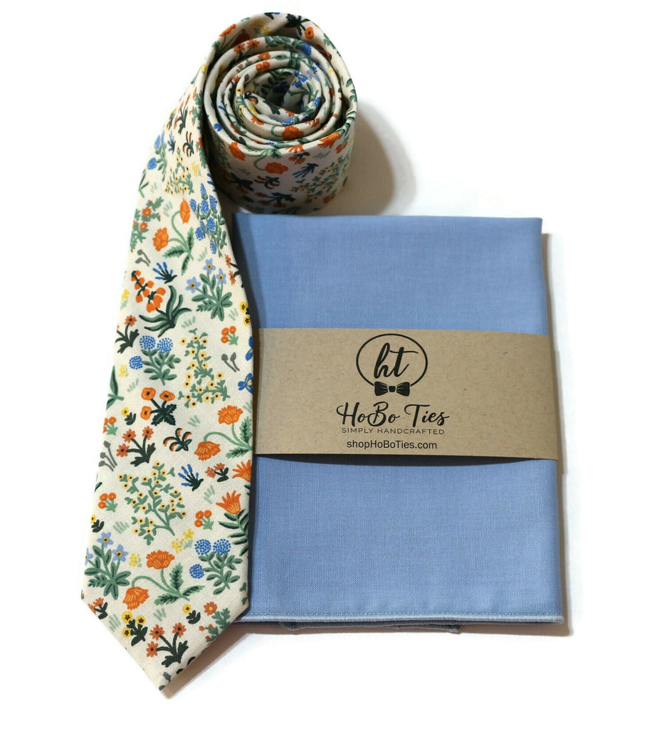 Cream Menagerie Garden Floral Necktie styled with a matching blue pocket square, perfect for men and boys' formal wear.