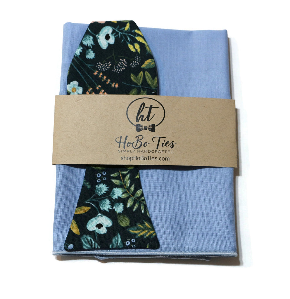 Navy Amalfi Floral Bow Tie displayed with a light blue pocket square, perfect for men's formal wear accessories.
