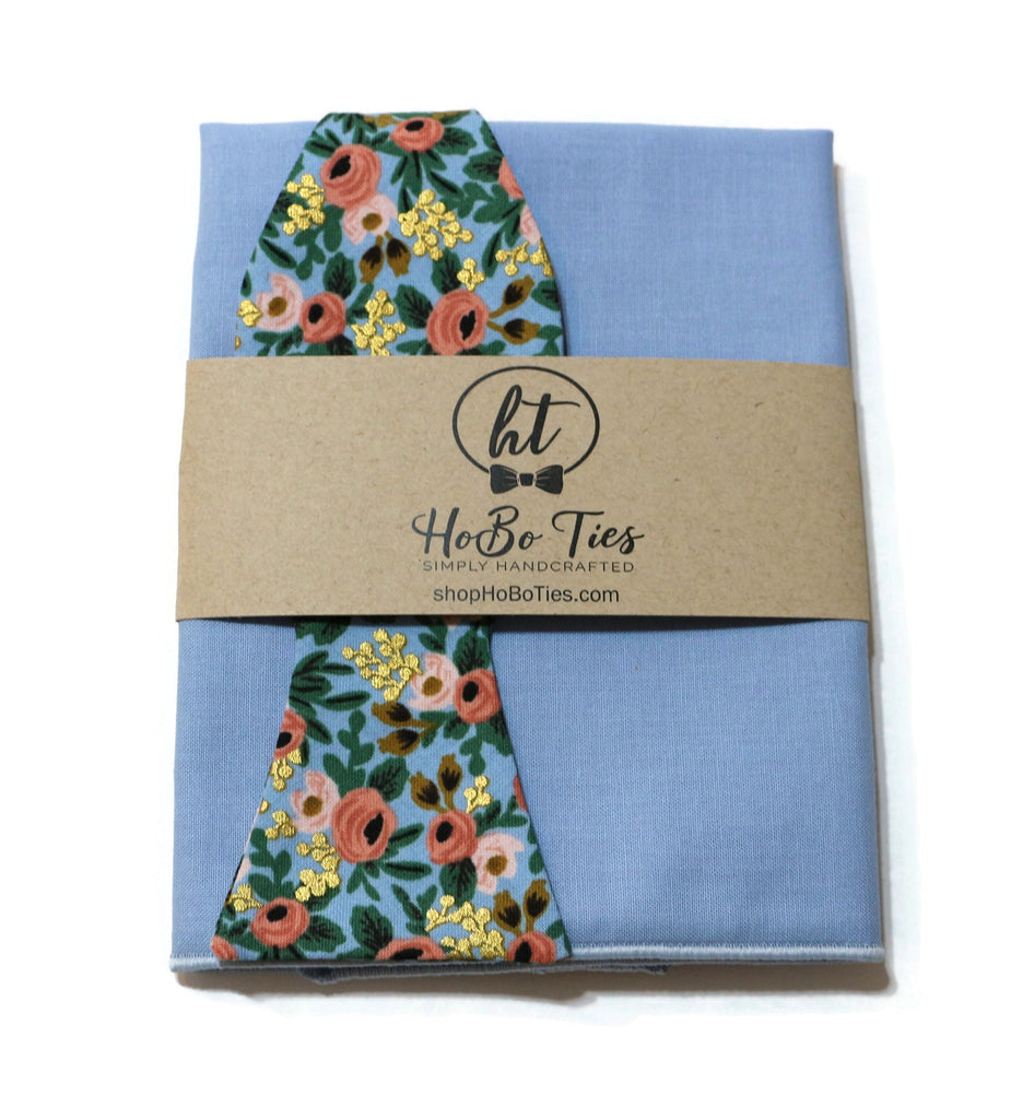 Chambray Metallic Rosa Floral Bow Tie with floral design on blue background, a perfect option for handcrafted neckties.
