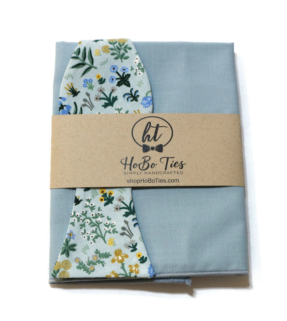Mint Menagerie Garden Floral Bow Tie packaged with a blue cloth and floral accent, perfect for weddings and formal occasions.