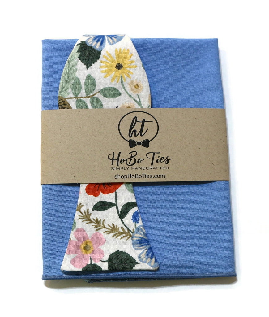 Ivory Strawberry Fields Floral Bow Tie with blue pocket square and floral pattern, handcrafted for unique men’s accessories.