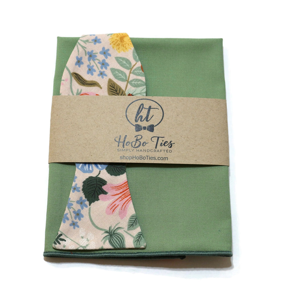 Blush Strawberry Fields Floral Bow Tie displayed with packaging on a green background, perfect for wedding accessories for men.